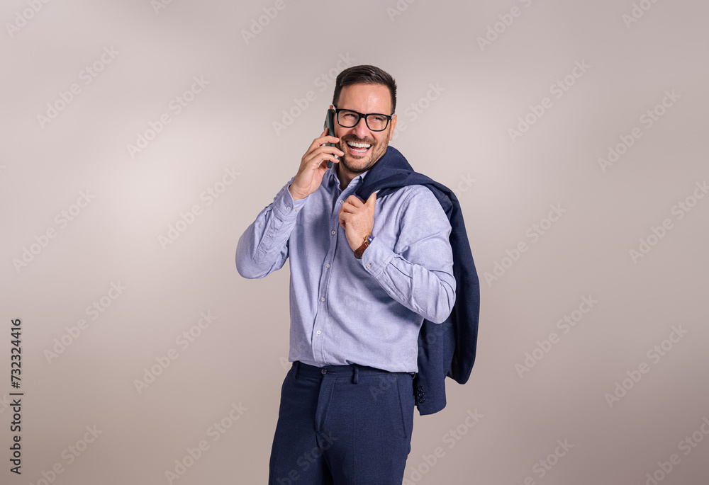 Successful happy businessman with blazer talking with client over mobile phone on white background Successful happy businessman with blazer talking with client over mobile phone on white background