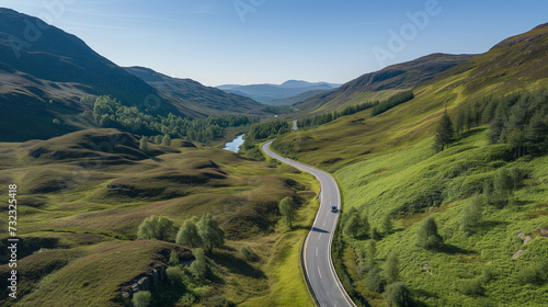 Aerial View of Winding Road Through Lush Highland Valleys, Scenic Route in Green Mountains, Breathtaking Landscape, Peaceful Nature Drive, Remote Travel Destination © AIRina