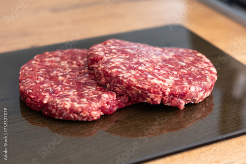 Beef cutlet for burger on cutting board