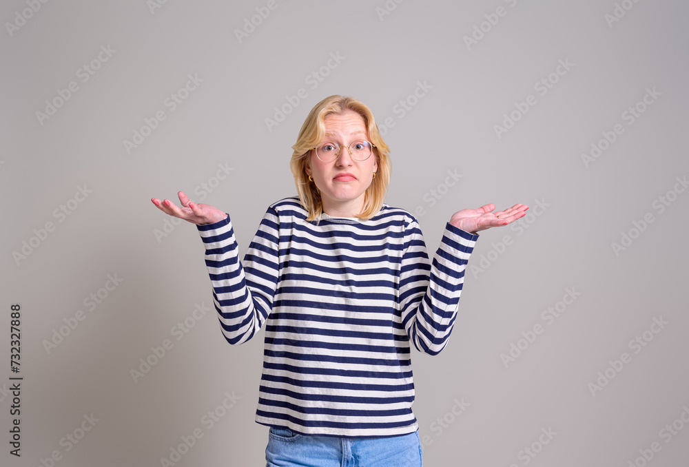 Portrait of careless female entrepreneur spreading hands and shrugging shoulders on white background Portrait of careless female entrepreneur spreading hands and shrugging shoulders on white background