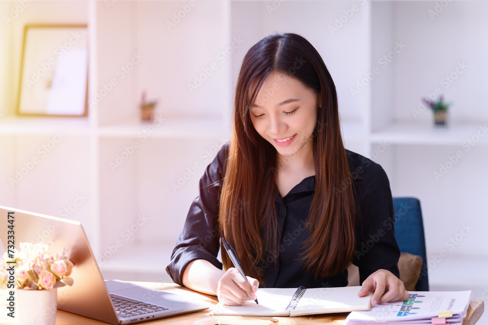 Businesswoman working in front of a laptop in the office. Businesswoman working in front of a laptop in the office.