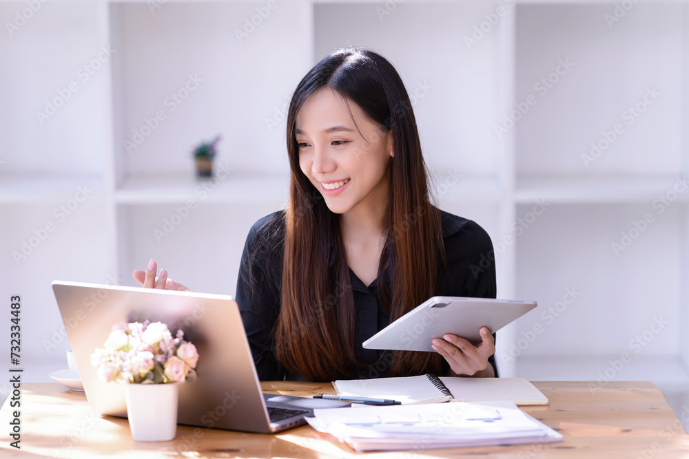 Businesswomen working online meet in front of a laptop in the office. Businesswomen working online meet in front of a laptop in the office.