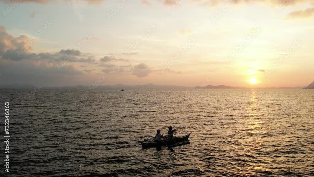 Pêcheurs sur une barque au coucher de soleil Pêcheurs sur une barque au coucher de soleil