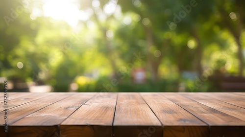 Empty wooden table with party in garden background blurred © Tahir