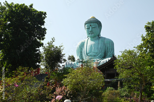 Outdoor great Buddha Daibutsu or Amitabhe Buddha at Wat Pra That Doi Pra Chan. It is a green rust Buddha statue made from a mixture of copper that was used to create it. Lacated at Lampang, Thailand. photo