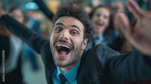 Ecstatic man taking a photo shoot with a group.