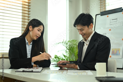 Wallpaper Mural Young businesspeople analyzing graphs and charts, preparing economic report at office Torontodigital.ca