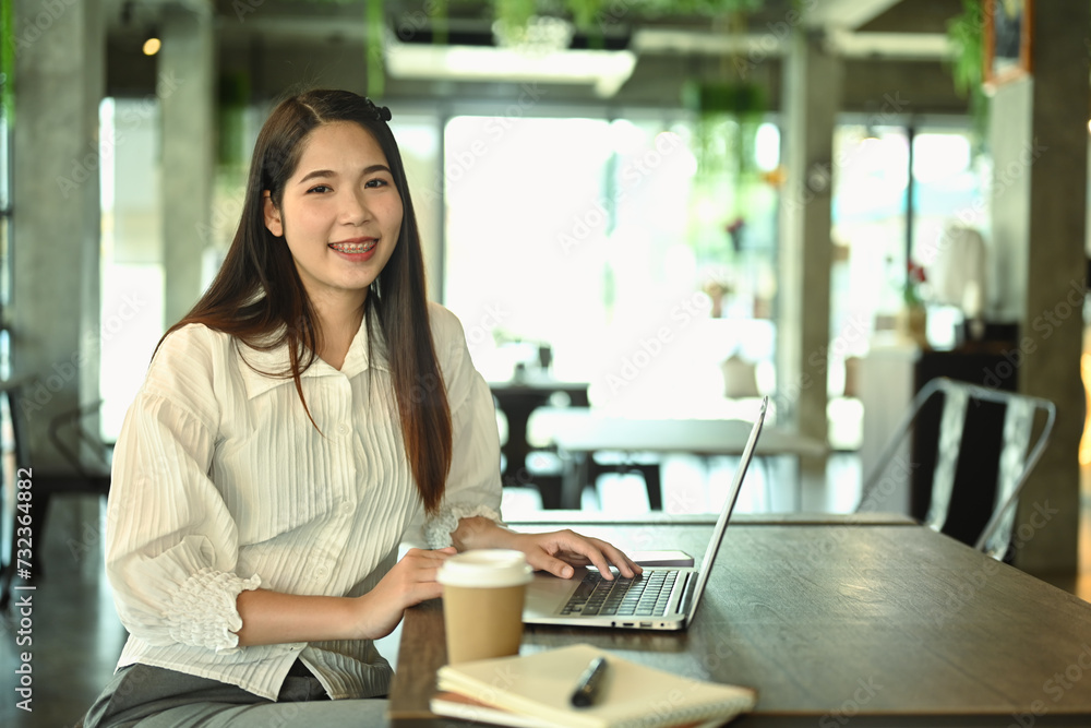 Portrait of beautiful businesswoman using laptop at startup business office Portrait of beautiful businesswoman using laptop at startup business office