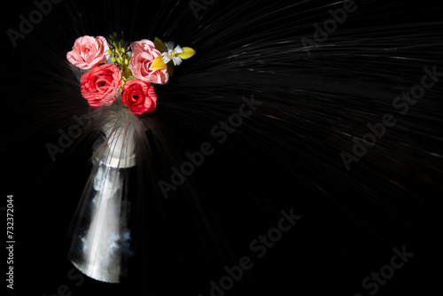 Bouquet of flowers in the vase on a black background