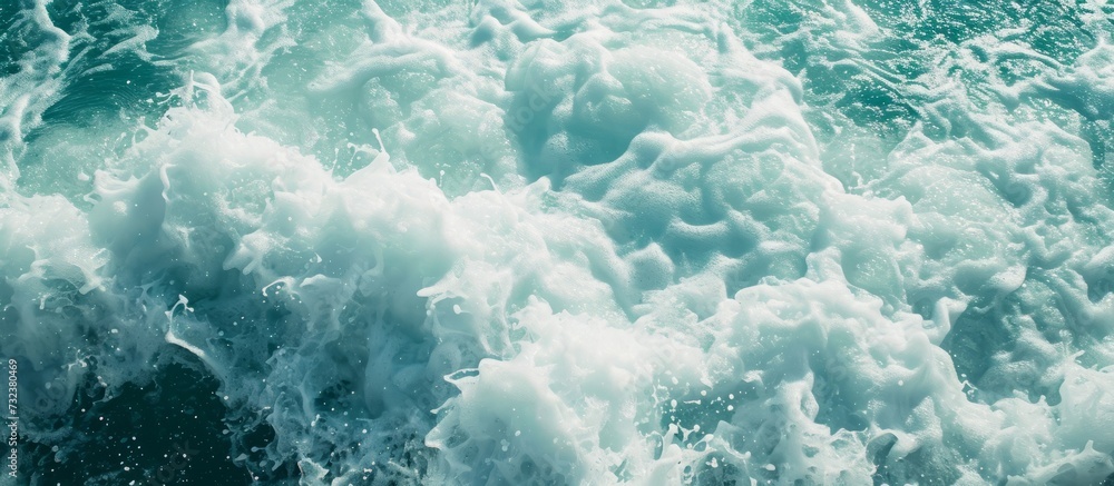 A close-up image showcasing azure waves crashing against a rock, creating a captivating water pattern under electric blue cumulus clouds. A close-up image showcasing azure waves crashing against a rock, creating a captivating water pattern under electric blue cumulus clouds.