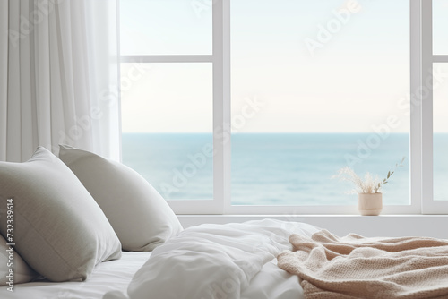 detail of a romantic room with the cutout of a bed with white sheets overlooking the blue sea photo