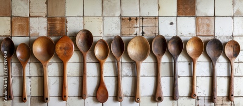 A collection of wooden spoons decorates the tiled wall, adding a touch of rustic charm to the kitchen decor.