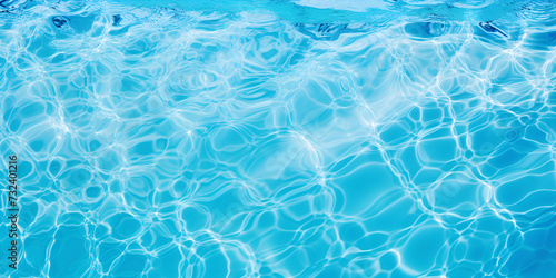 Water in swimming pool blue background Beautiful Gentle wave in swimming pool with sun reflection.