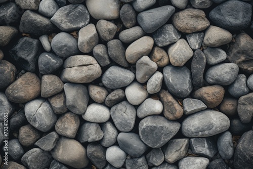 A close-up view of a pile of rocks. This image can be used to depict stability, nature, or construction