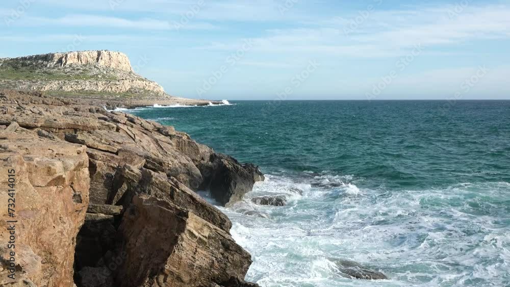 Beautiful rocks and waves on the ocean. Beautiful coastline with turquoise water. Aphrodite's rock a famous tourist travel destination landmark in Paphos, Cyprus.
