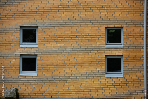 Four small windows in a brick wall.