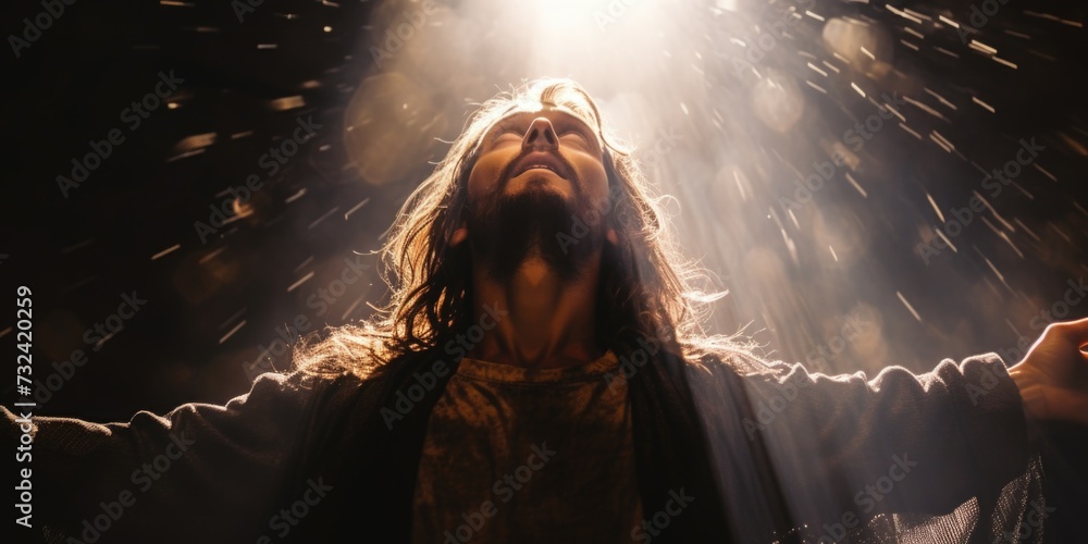 A man with long hair standing in front of a bright light. Can be used to represent enlightenment or a moment of clarity A man with long hair standing in front of a bright light. Can be used to represent enlightenment or a moment of clarity