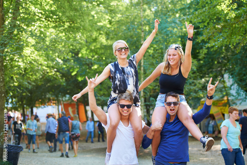 People, happy and crazy celebration in forest for cheerful, bonding or fun outdoors together in nature. Group of friends, smile and excited in summer for festival, camping or social event in park
