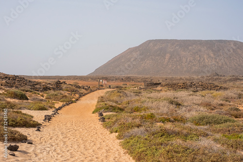 Camino de arena entre paisaje intacto en Isla de Lobos, Canarias photo