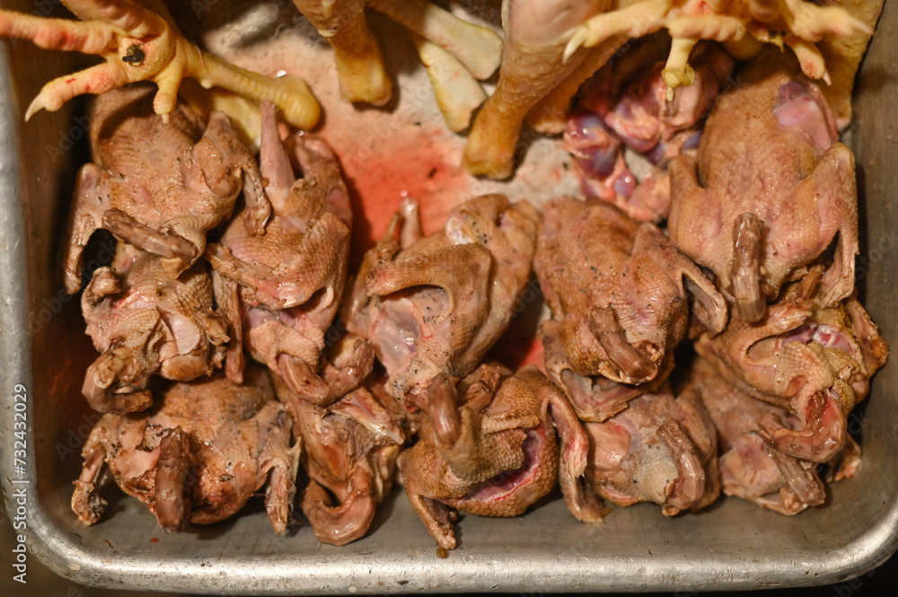 carcasses of plucked pigeon meat without a head, chicken legs carcasses of plucked pigeon meat without a head, chicken legs