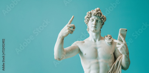 Classical Statue with a Modern Twist Holding a Smartphone, Turquoise Background photo