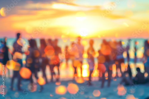 Blurred people having sunset beach party in summer vacation.
