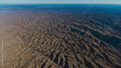 view of a desert with a long line of tracks 