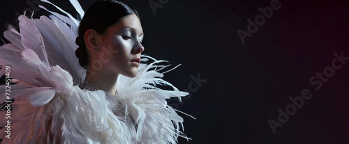 Stylish woman with feathers on clothes photo