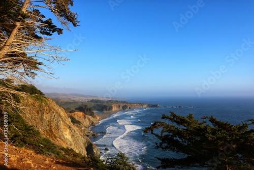 an image of the ocean and a coastline with cliffs on it