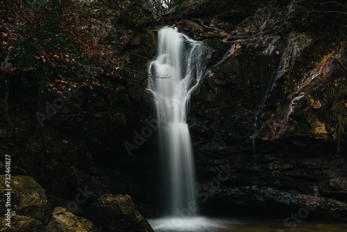 Scenic view of a waterfall cascading down between large rocks
