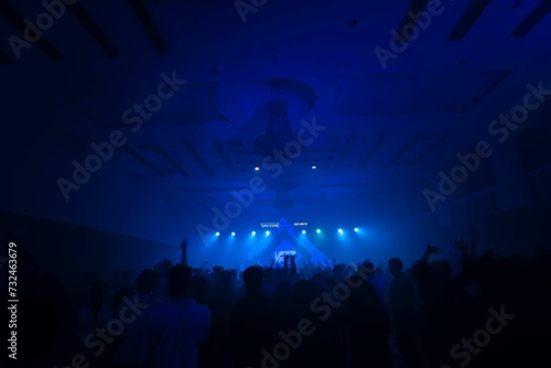 Tablou pe pânză Illuminated stage during a live music performance in a dimly lit venue with the