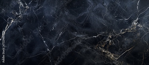 A detailed view of a black and gold marble texture, resembling a natural landscape with water, freezing sky, twigs, grass, and soil, creating a mesmerizing pattern with hints of darkness.