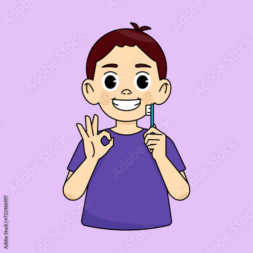 The boy holds a toothbrush, the other hand shows the OK sign with his fingers. Oral cleanliness and hygiene concept