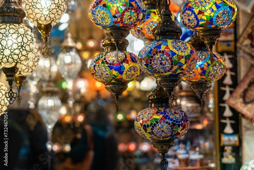 Ornate and vibrant collection of Turkish lamps hanging in front of a market