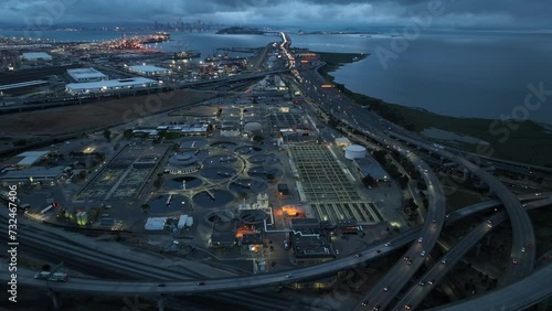 Drone view over an industrial field between on controlled-access roads on a waterfront in evening photo