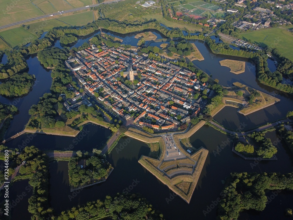 Fototapeta premium Scenic aerial view of the Fortress town of Naarden-Vesting surrounded by a tranquil lake