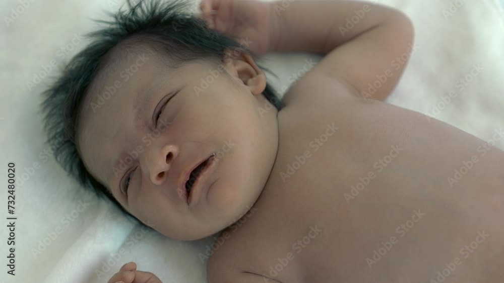 Newborn crying baby girl New born child tired and hungry on bed Infant just wake up and crying Infant screaming angry and calling mother for feeding milk Healthy little kid shortly after birth	