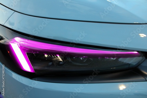 Closeup of a purple led light of a car's headlight