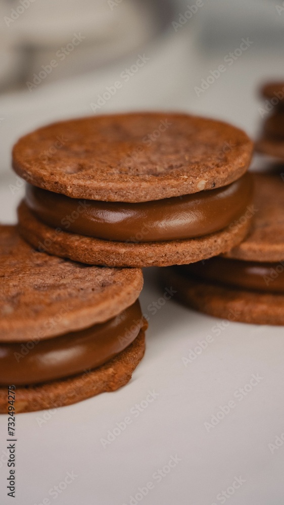 Close-up of fresh homemade chocolate cookies on a white table Close-up of fresh homemade chocolate cookies on a white table