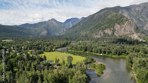 Tranquil Leavenworth wenatchee river through lush green forested mountains in the valley photo