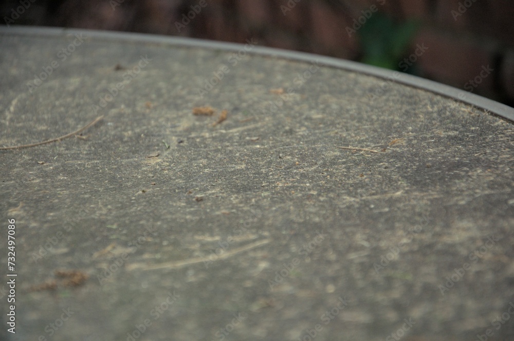 Macro shot of a grungy table surface, showing dirt and debris