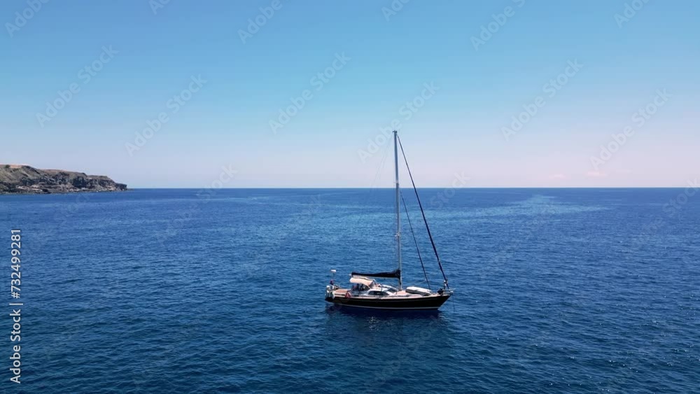 Landscape scene of a boat in the blue water sea by range rocky hills for wallpaper Landscape scene of a boat in the blue water sea by range rocky hills for wallpaper