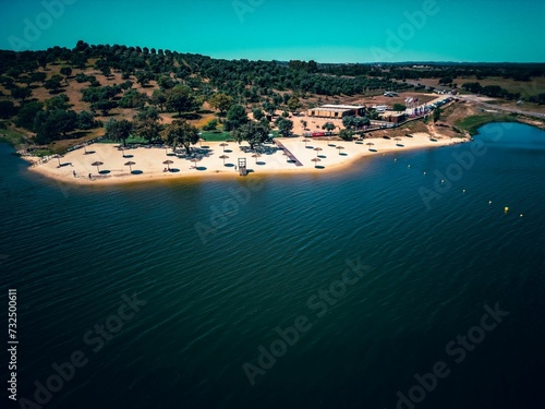 Aerial view of a picturesque resort located on a serene stretch of sandy beach