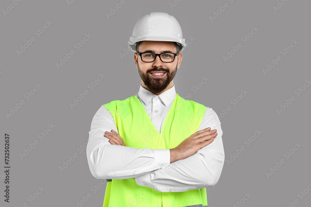 Engineer in hard hat on grey background Engineer in hard hat on grey background