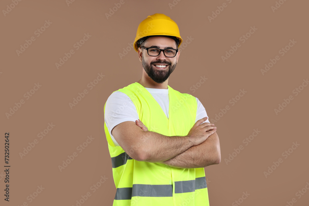 Engineer in hard hat on brown background Engineer in hard hat on brown background