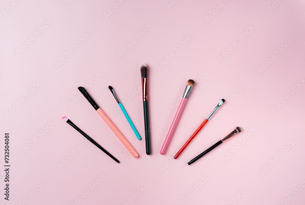 Makeup brushes on pink background. Top view point, flat lay. Makeup brushes on pink background. Top view point, flat lay.
