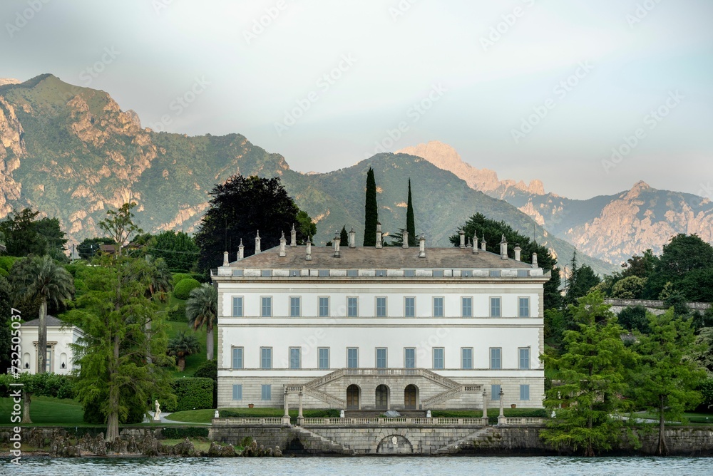 Fototapeta premium Villa Melzi D'Eril mansion surrounded by lush, verdant gardens and tall, majestic trees