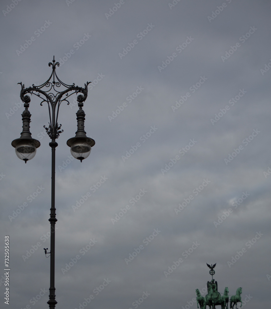 Old streetlight on the street on a cloudy evening