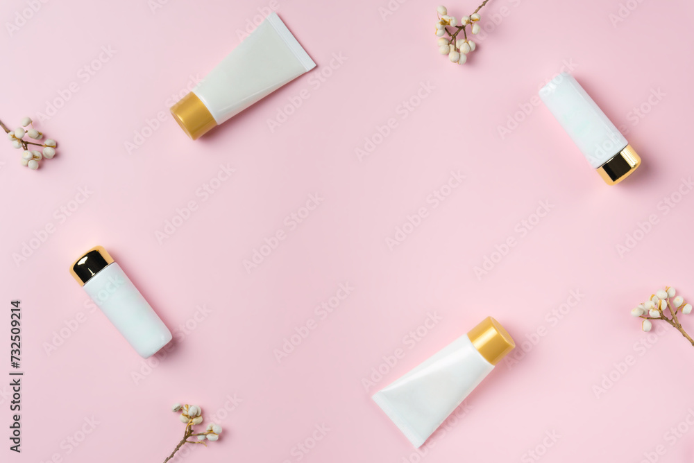 Set of white tubes on a pink background, top view Set of white tubes on a pink background, top view