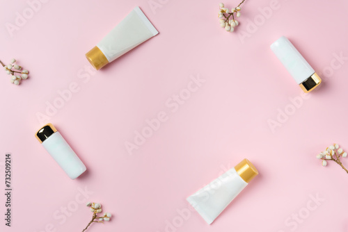 Set of white tubes on a pink background, top view